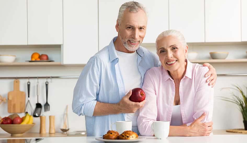 cheerful-mature-loving-couple-family-standing-kitchen-oral-health-dental-care