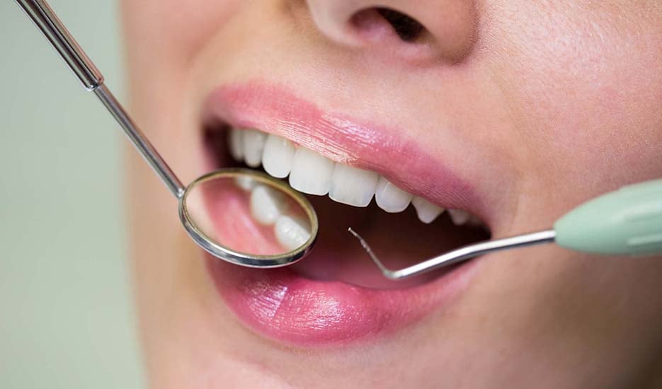 dentist-examining-female-patient-with-tools-dental-care-oral-health