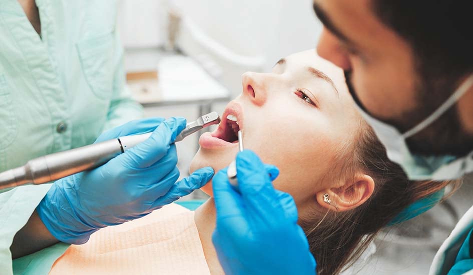 dentists-using-dental-drill-and-sucker-while-exami-dental-care-oral-health