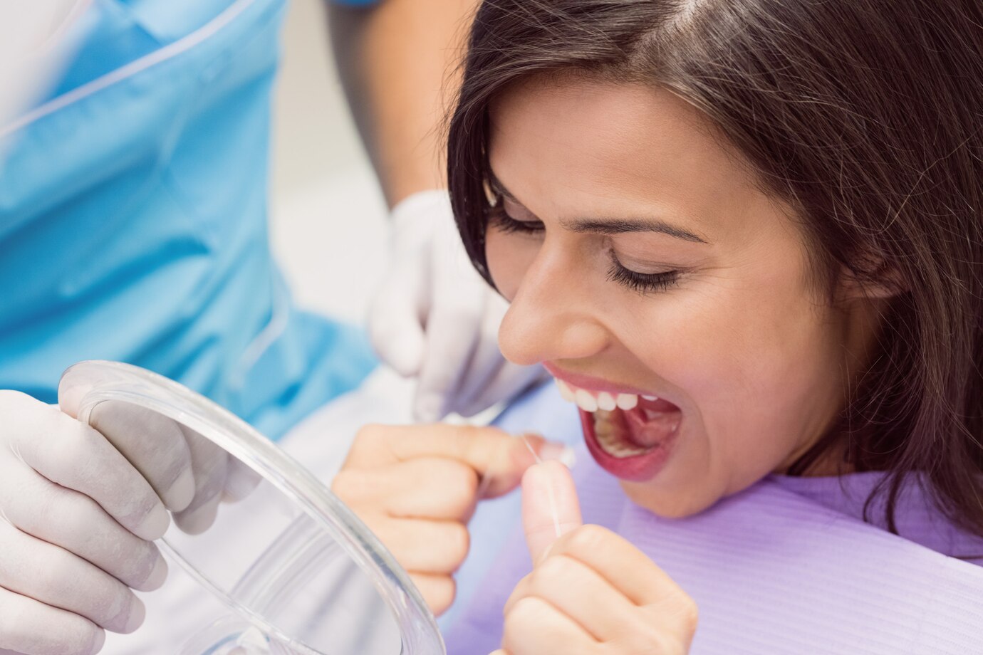 female-patient-flossing-her-teeth_107420-65474