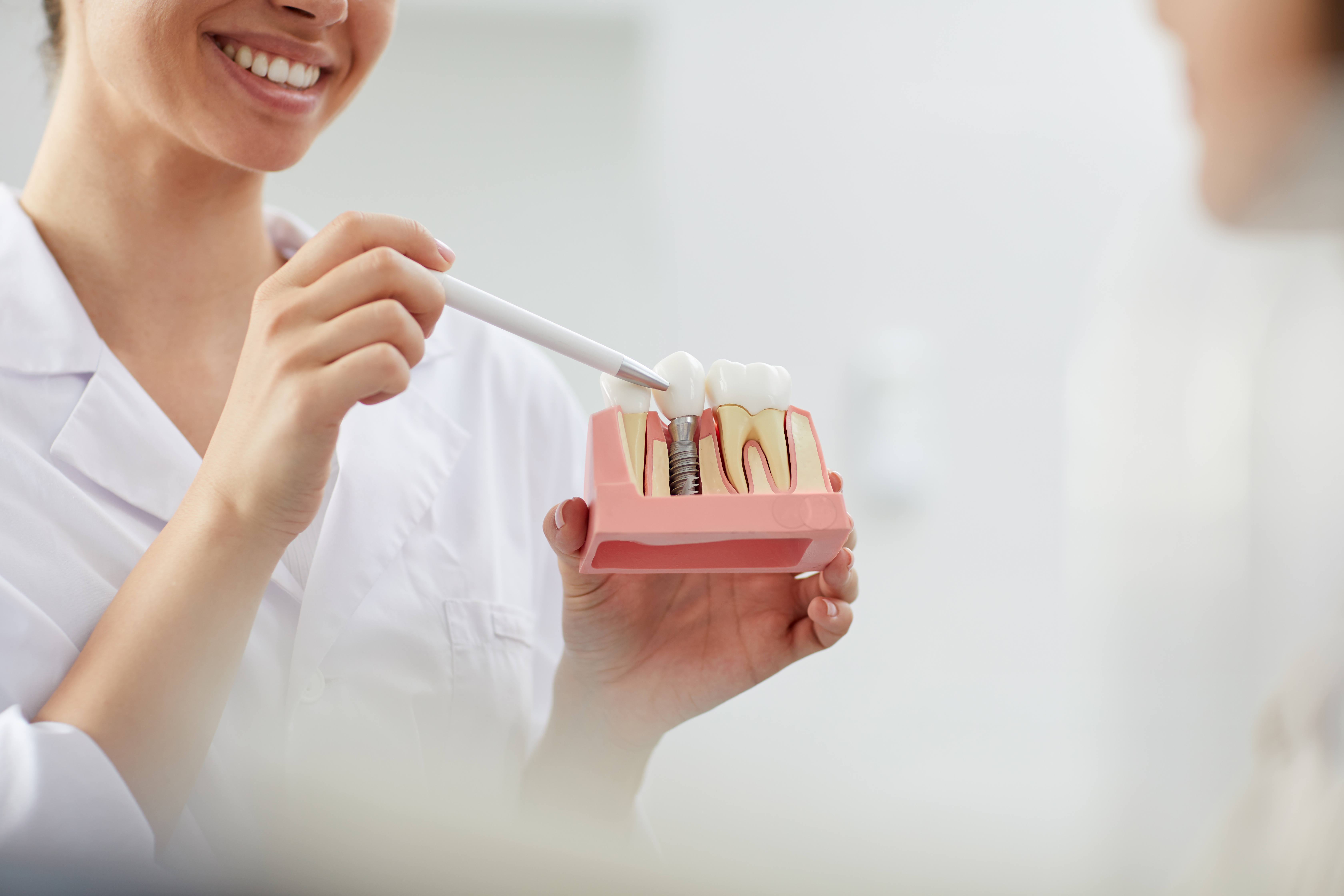 dentist showing implant model