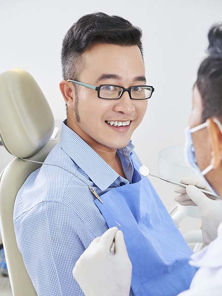 cheerful-asian-man-dentist-smile-happy-dental-care-check-up