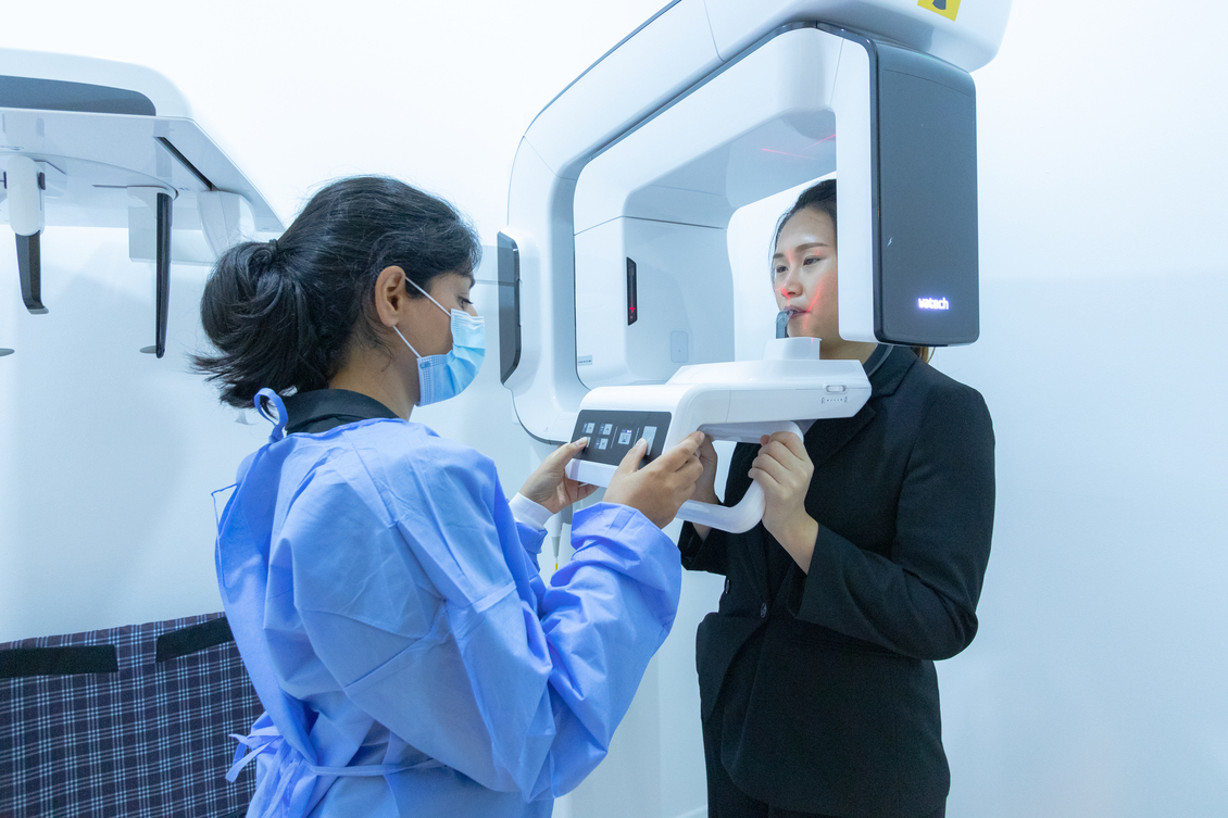 holland village dental - woman dressed in black getting a dental scan