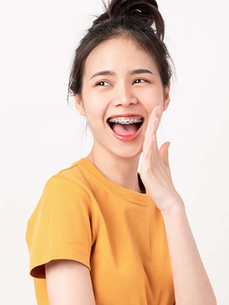 what-are-damon-braces-young-girl-happy-smiling-shy-dental-health-care-check-up-yellow-shirt