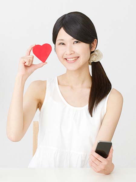 why-should-you-get-your-teeth-whitened-happy-asian-girl-smile-heart-holding-phone-dental-care-oral-health