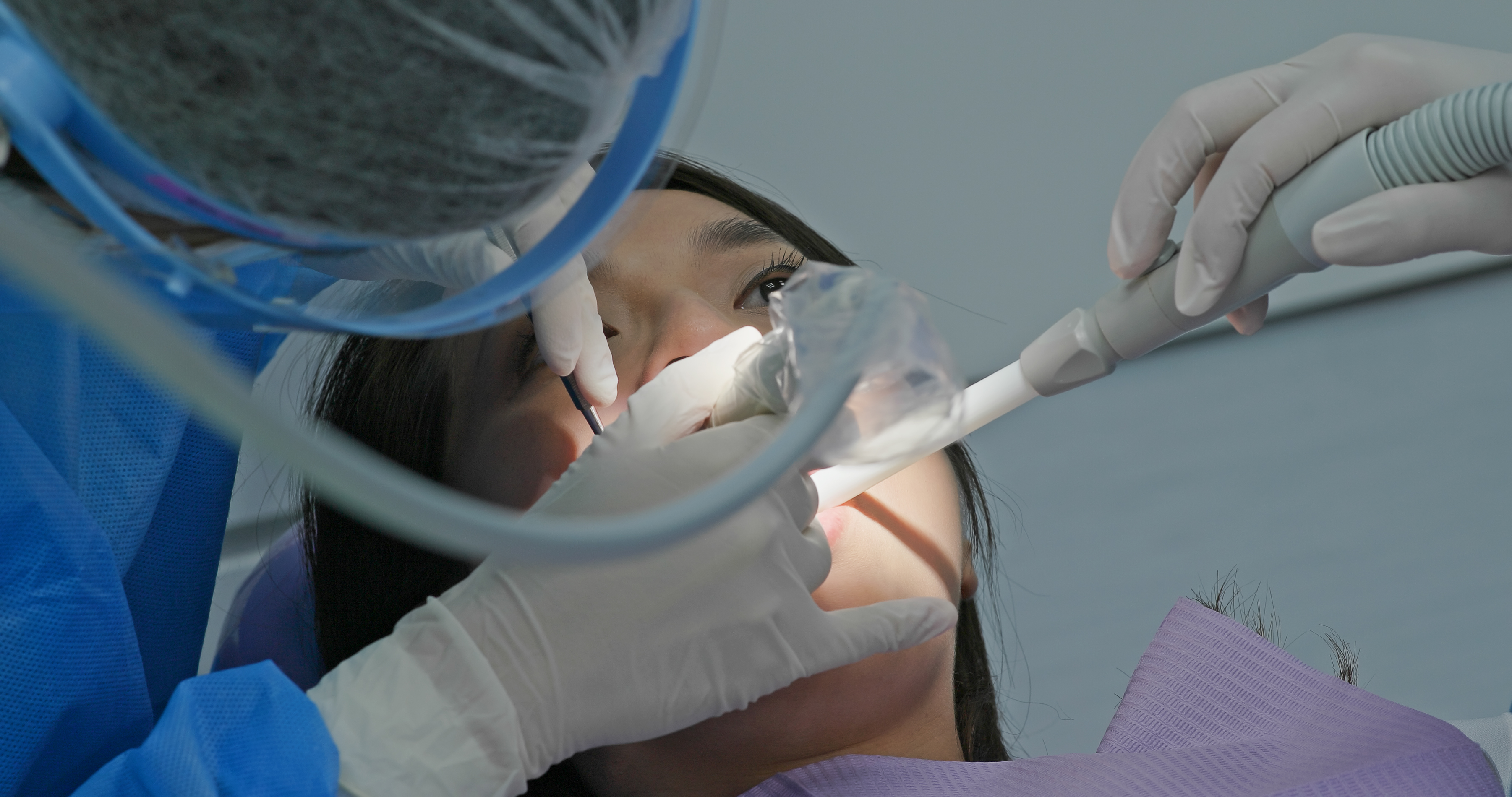 woman-undergo-dental-scaling-treatment-7VD7QCP
